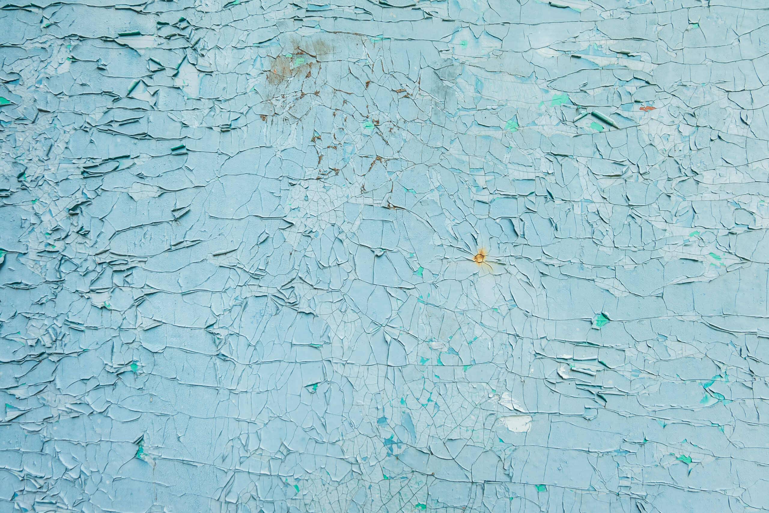 cracked blue paint on a wooden door